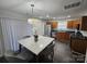 An inviting kitchen with stainless steel appliances and a stylish, modern dining table at 10904 Pimlico Dr, Charlotte, NC 28273