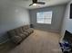 This comfortable room features a futon and a large window at 10904 Pimlico Dr, Charlotte, NC 28273