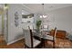 Dining area with glass table, four chairs, and access to living room at 12250 Savannah Garden Dr, Charlotte, NC 28273