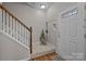 Entryway with coat hooks, plant, and wooden staircase at 12250 Savannah Garden Dr, Charlotte, NC 28273