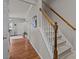 Wood and white staircase leading to the second floor at 12250 Savannah Garden Dr, Charlotte, NC 28273