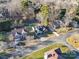 Aerial view of the property showcasing its well-manicured lawn, tree-lined street, and proximity to neighboring homes at 12527 Cedar Post Ln, Charlotte, NC 28215