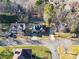 Aerial view of the property showcasing its well-manicured lawn, tree-lined street, and proximity to neighboring homes at 12527 Cedar Post Ln, Charlotte, NC 28215