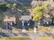 Overhead view of the home with an expansive driveway, well-maintained lawn, and surrounding mature trees at 12527 Cedar Post Ln, Charlotte, NC 28215