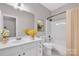 Neutral toned bathroom with a white vanity, framed mirror, and shower-tub combo at 12527 Cedar Post Ln, Charlotte, NC 28215