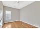 Empty room with hardwood floors, neutral walls, and natural light at 12527 Cedar Post Ln, Charlotte, NC 28215