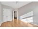 Empty bedroom featuring hardwood floors, natural light, and closet space at 12527 Cedar Post Ln, Charlotte, NC 28215