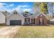 Charming home with a brick facade, well-maintained lawn, and a two-car garage at 12527 Cedar Post Ln, Charlotte, NC 28215