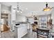 Open-concept living space with a fireplace, modern lighting, and an eat-in kitchen island with granite countertops at 12527 Cedar Post Ln, Charlotte, NC 28215