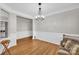 Living room featuring hardwood floors, neutral paint, and large windows at 12527 Cedar Post Ln, Charlotte, NC 28215