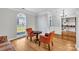 Living room featuring two orange chairs, hardwood floor, and large windows at 12527 Cedar Post Ln, Charlotte, NC 28215