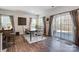 Bright dining area with wood floors, modern table and chairs, and sliding glass doors to the outdoor patio at 1328 Lena St, Monroe, NC 28112