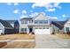 Charming two-story home with gray siding, blue shutters, and a two-car garage at 1328 Lena St, Monroe, NC 28112