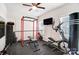 Well-equipped home gym with weightlifting equipment, exercise machines, and a ceiling fan for comfort at 1328 Lena St, Monroe, NC 28112