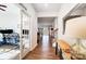 Bright hallway featuring wood floors, white walls, and an office space visible through glass doors at 1328 Lena St, Monroe, NC 28112