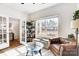 Bright office space with a brown leather sofa, lots of natural light, and a glass top table at 1328 Lena St, Monroe, NC 28112