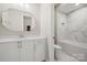 Modern bathroom featuring a white vanity, marble tile, and bathtub at 13308 Oak Farm Ln, Huntersville, NC 28078