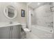 Clean bathroom with gray vanity, marble tile, and a shower/tub combo at 13308 Oak Farm Ln, Huntersville, NC 28078