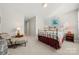 Spacious bedroom with sitting area and a metal bed frame at 13308 Oak Farm Ln, Huntersville, NC 28078