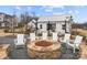 Community fire pit with white Adirondack chairs and a stone fire pit at 13308 Oak Farm Ln, Huntersville, NC 28078