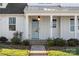 Front entry with light blue door, stone steps, and lantern at 13308 Oak Farm Ln, Huntersville, NC 28078