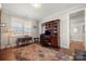 Home office with built-in bookcase and hardwood floors at 13308 Oak Farm Ln, Huntersville, NC 28078