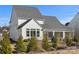 Rear view of house, showcasing screened porch and landscaping at 13308 Oak Farm Ln, Huntersville, NC 28078