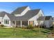 Two-story home with a screened porch and stone accents at 13308 Oak Farm Ln, Huntersville, NC 28078