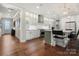 Open concept kitchen features white cabinetry, breakfast bar, and hardwood floors at 13308 Oak Farm Ln, Huntersville, NC 28078