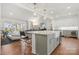 Open kitchen with island, white cabinets, and granite countertops at 13308 Oak Farm Ln, Huntersville, NC 28078