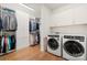 Bright laundry room with washer, dryer, and ample storage at 13308 Oak Farm Ln, Huntersville, NC 28078