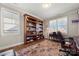 Bright home office features built-in bookshelves and a desk at 13308 Oak Farm Ln, Huntersville, NC 28078