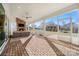 Screened porch with brick flooring and a stone fireplace at 13308 Oak Farm Ln, Huntersville, NC 28078