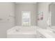 Bathroom with soaking tub, double vanity and natural light at 15214 Mccomb Manor Ct, Charlotte, NC 28277