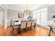 Bright dining room featuring a large glass table and hardwood floors at 15214 Mccomb Manor Ct, Charlotte, NC 28277