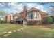 Brick house with a deck and landscaped yard at 15214 Mccomb Manor Ct, Charlotte, NC 28277