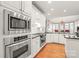 Modern kitchen with stainless steel appliances and white cabinetry at 15214 Mccomb Manor Ct, Charlotte, NC 28277