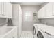 Laundry room with washer, dryer, and ample cabinet storage at 15214 Mccomb Manor Ct, Charlotte, NC 28277