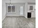 Simple dining area with gray tile floors and sliding glass doors at 165 Bowman Rd, Statesville, NC 28625