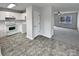 White kitchen with tile floors and stainless steel appliances at 165 Bowman Rd, Statesville, NC 28625