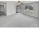 Bright living room featuring gray carpeting and access to front porch at 165 Bowman Rd, Statesville, NC 28625