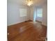 Bright bedroom with hardwood floors and window blinds at 1814 Logie Ave, Charlotte, NC 28205