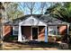 Brick ranch house with a covered porch and mature trees at 1814 Logie Ave, Charlotte, NC 28205