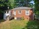 Brick house back with a wooden deck and fenced yard at 1814 Logie Ave, Charlotte, NC 28205