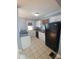 Galley kitchen with white cabinets and black appliances at 1814 Logie Ave, Charlotte, NC 28205