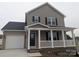 Charming two-story home with a welcoming front porch, attached garage, and neutral-colored siding at 1875 Terrain Nw Dr, Conover, NC 28613