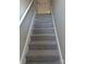 Carpeted staircase with white rails leads to the upper level of the home at 1875 Terrain Nw Dr, Conover, NC 28613