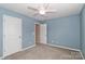 Blue-walled bedroom with ceiling fan and door to hallway at 201 Waterlynn Ridge Rd # E, Mooresville, NC 28117