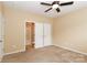 Bedroom with private bathroom access and carpet at 201 Waterlynn Ridge Rd # E, Mooresville, NC 28117