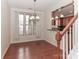 Charming dining room featuring hardwood floors, a chandelier, and kitchen pass-through at 201 Waterlynn Ridge Rd # E, Mooresville, NC 28117